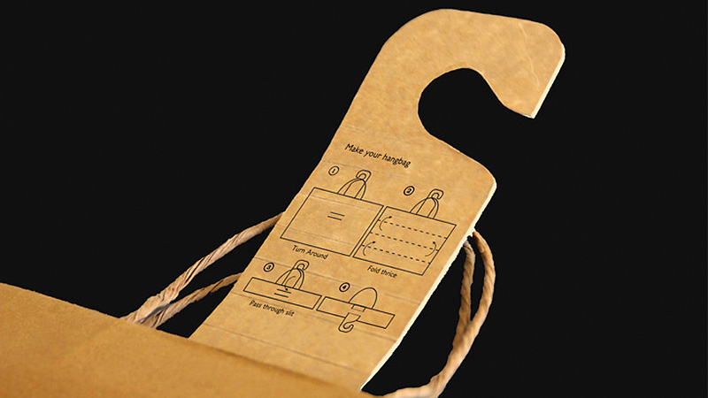 A Paper Shopping Bag That Transforms Into A Hanger Back Home