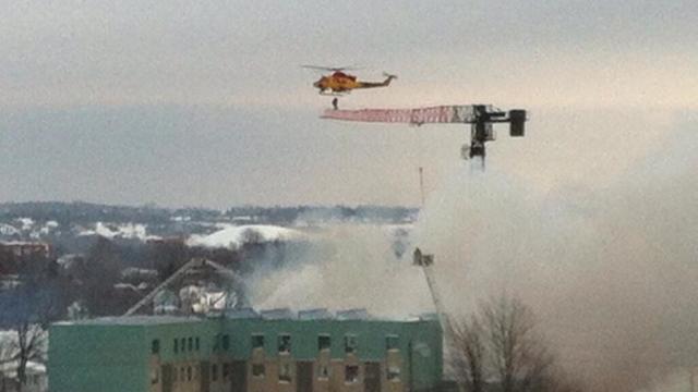 Helicopter Incredibly Rescues A Man Trapped On A Crane After Explosion
