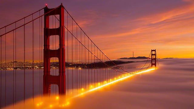 The Golden Gate Bridge Looks Like A Bright Streak Of Fire In Fog