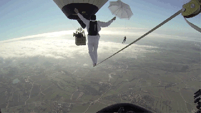 Insane People Walk A Line Between Hot Air Balloons Above The Clouds
