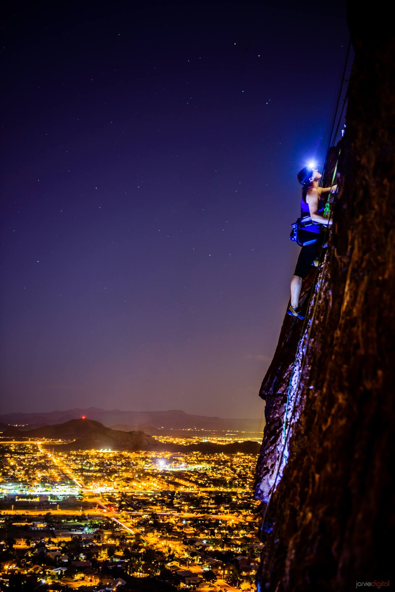 Spectacular Photo Of A Woman Climbing A Vertical Rock Wall At Night