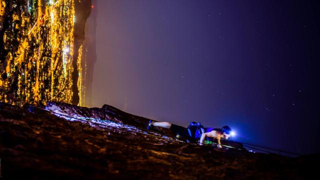 Spectacular Photo Of A Woman Climbing A Vertical Rock Wall At Night