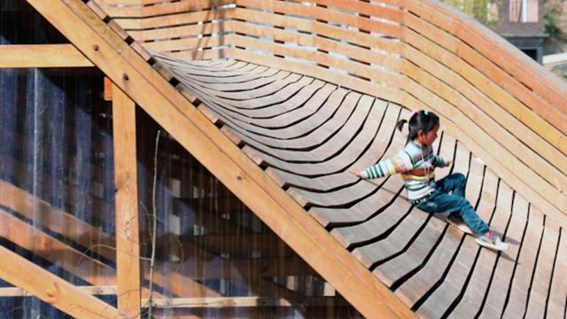 The Roof Of This Sloped Library Doubles As An Awesome Slide
