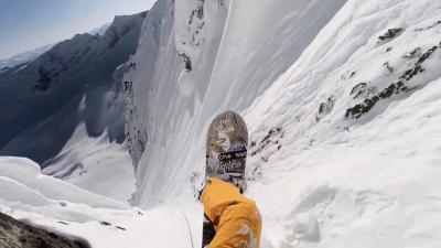Insane Guy Rappels Down Vertical Rock Wall To Snowboard At Hyperspeed