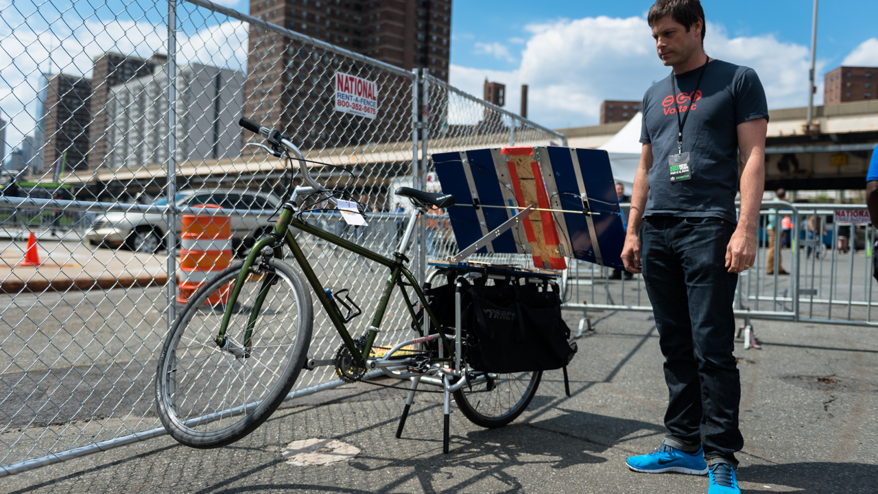 This Apocalypse-Ready Solar Charging Station Folds Up Behind A Bike
