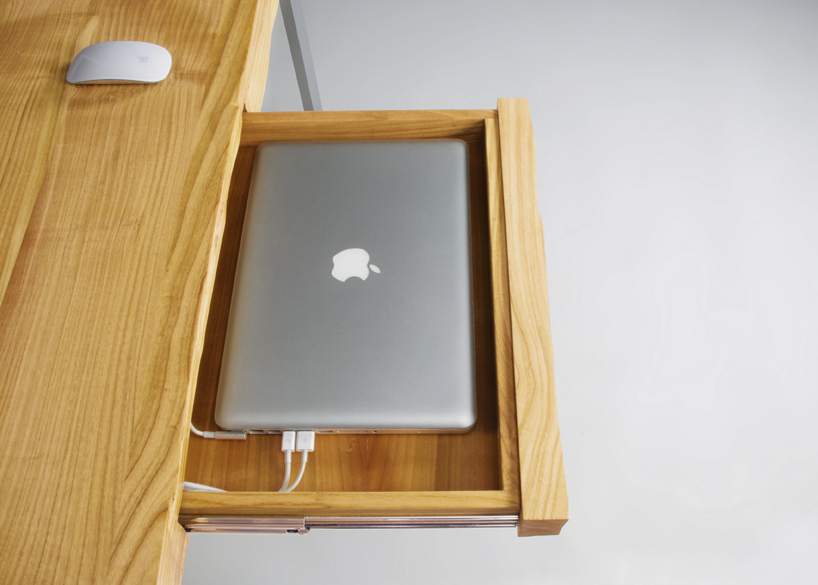 This Undulating Desk Top Has Specially Carved Crevices For Your Tech