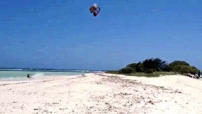 Watch This Guy Jump Over An Entire Island While Kitesurfing