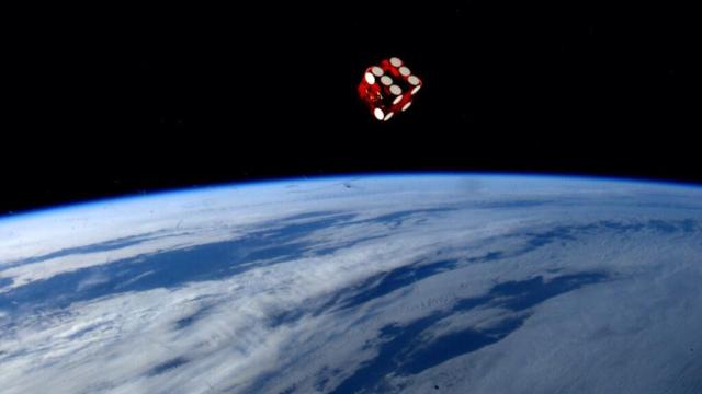 This Image Of A Dice Rolling In Space Over The Earth Is Not A Photoshop