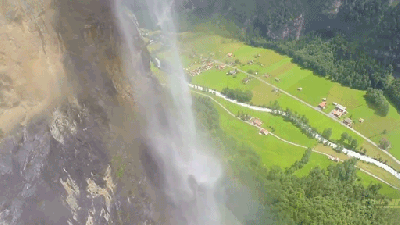 Mad Man In A Wingsuit Flies Through A Waterfall