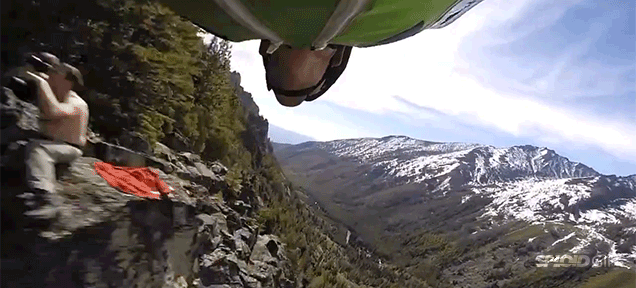 Flying Man Flies So Close To The Cliff That He Can High Five Someone