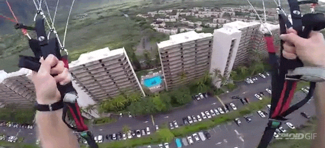Paraglider Daredevil Swoops Right In Between Two Buildings