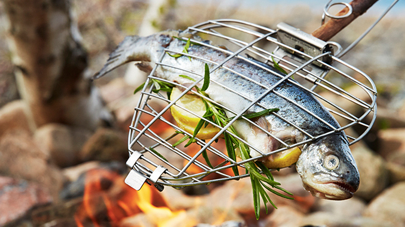 Put This Compact Grill On A Stick To Turn A Campfire Into A BBQ