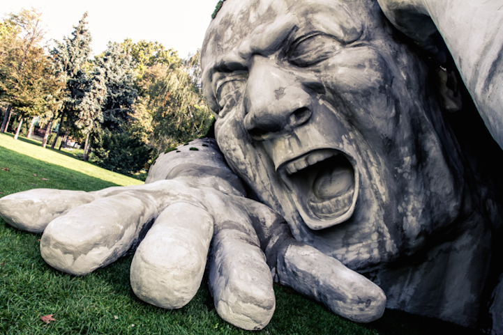 Scary, Giant Man Crawls Out From The Ground In Shocking Outdoor Sculpture