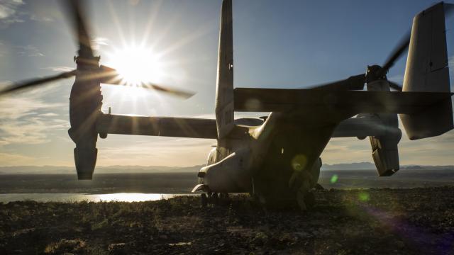 Peaceful Shot Of MV-22 Osprey Overlooking The Sun On Top A Mountain