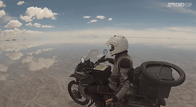 Riding A Motorcycle On Mirrored Salt Flats Looks Like Flying In The Sky