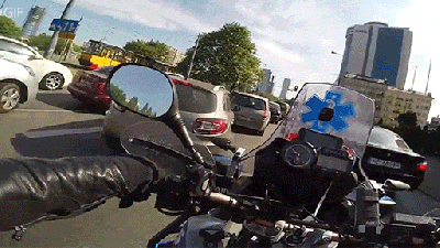 First-Person View Of A Motorcycle Ambulance Driving With Its Siren On