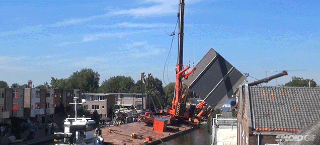 Two Giant Cranes Holding A Bridge Collapse Into Nearby Homes