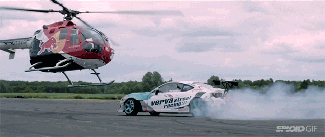 A Helicopter Closely Chases A Race Car In This Truly Insane Stunt