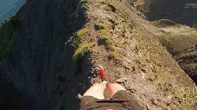 Crazy Runner Runs Along A Terrifyingly Narrow Ridge Of A Mountain