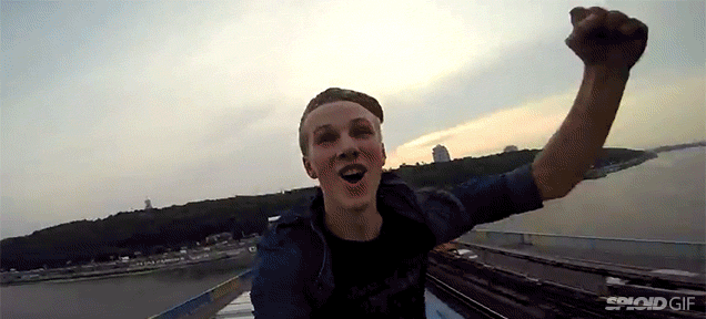 Daredevil Kid Rides A Train While On Top Of The Roof Of The Train