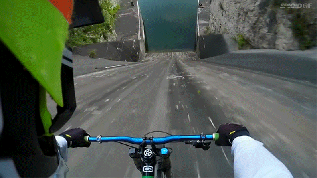 Cyclist Rides Straight Down The Vertical Wall Of A Dam And Plunge Crashes Into Water