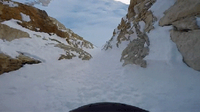 Daredevil Skis Through An Impossibly Narrow Gap In The Mountains