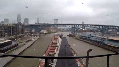 A Cool View Of A Ship Going Through A City On The River