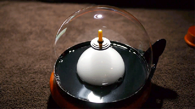 A Spinning Top Floating Inside A Smoke-Filled Bubble Looks Like Magic