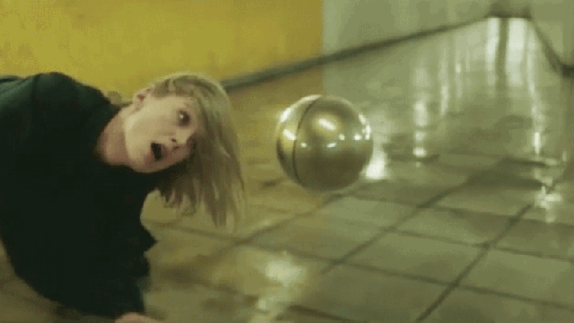 A Floating Orb Menaces Rosamund Pike In This Disturbing New Massive Attack Video