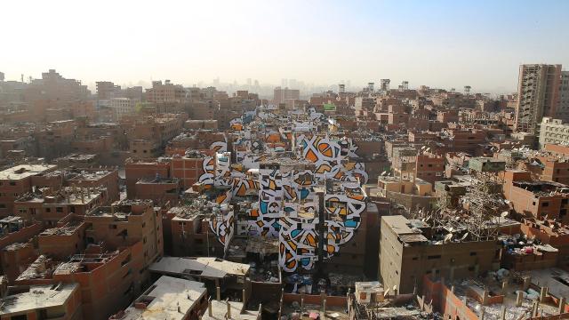 How A Street Artist Secretly Painted An Urban-Scale Mural In Cairo