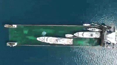 Giant Yacht Carrier Sinks Into The Water To Swallow Ships And Then Rises To Transport Them
