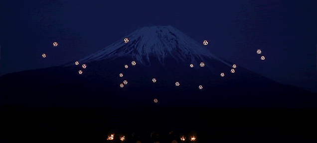These Drones Dancing In The Air Against A Mountain Look Like Real Life Space Invaders