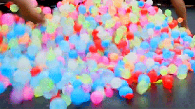 Bouncing On A Trampoline With Water Balloons Is The Best Way To Feel Like A Kid Again