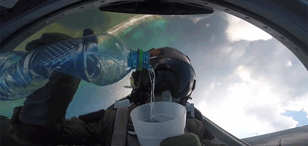 Cool View Of A Pilot Pouring Water Upside Down While Doing A Barrel Roll In A Fighter Jet