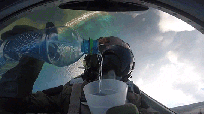 Cool View Of A Pilot Pouring Water Upside Down While Doing A Barrel Roll In A Fighter Jet