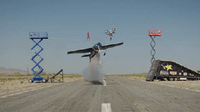Plane Flies Under A Biker Doing A Backflip And A Guy Walking On A Tight Rope