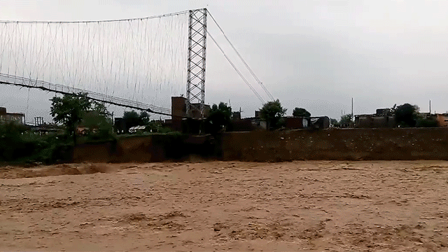Watch A Raging Flood Devour An Entire Suspension Bridge