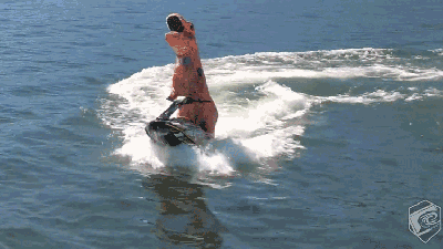Badarse T-Rex On A Jetski Is Exactly Why We’re Looking Forward To Summer