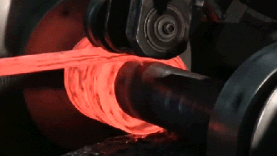 Watch A Red Hot Metal Rod Get Wound Up Into A Coil Spring
