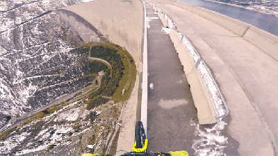 Biking On A Very Thin Handrail On Top Of A 200-Metre Tall Dam Is Stupidly Scary
