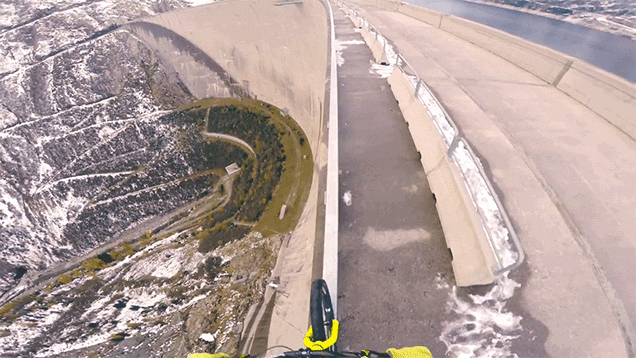 Biking On A Very Thin Handrail On Top Of A 200-Metre Tall Dam Is Stupidly Scary