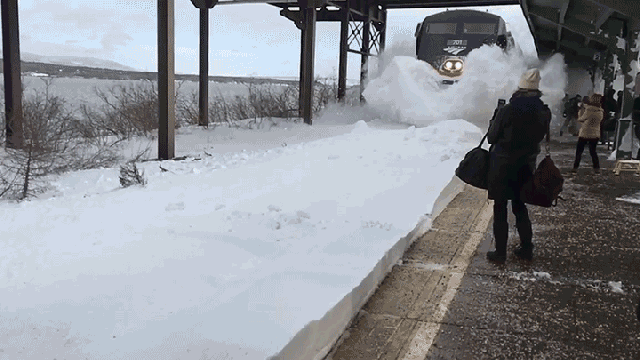 Watch A Speeding Train Blast A Bunch Of Commuters With Snow