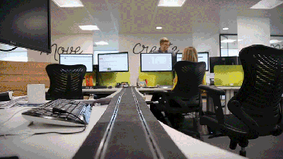 Every Office Should Have Slot Cars Racing Across All The Desks