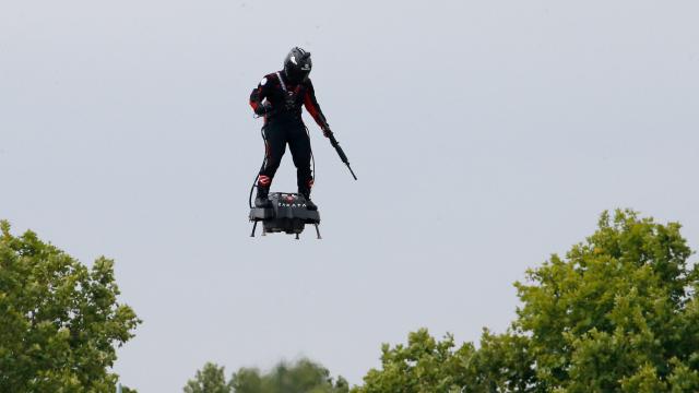 French Inventor Touts Rifle While Flying Turbine-Powered Flyboard At Bastille Day Celebrations