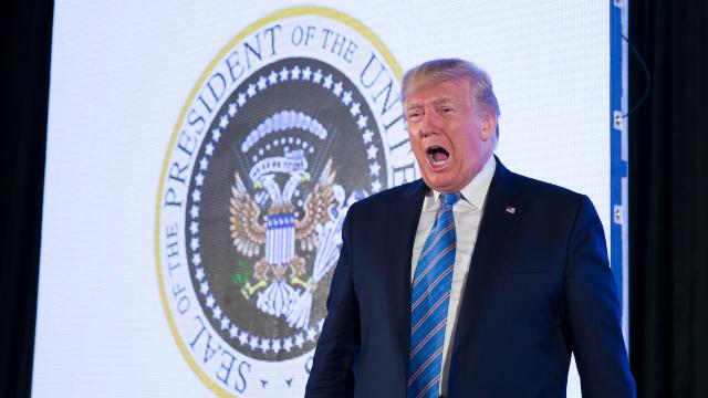 Trump Stands Next To Photoshopped Presidential Seal That Reads ’45 Is A Puppet’ In Spanish