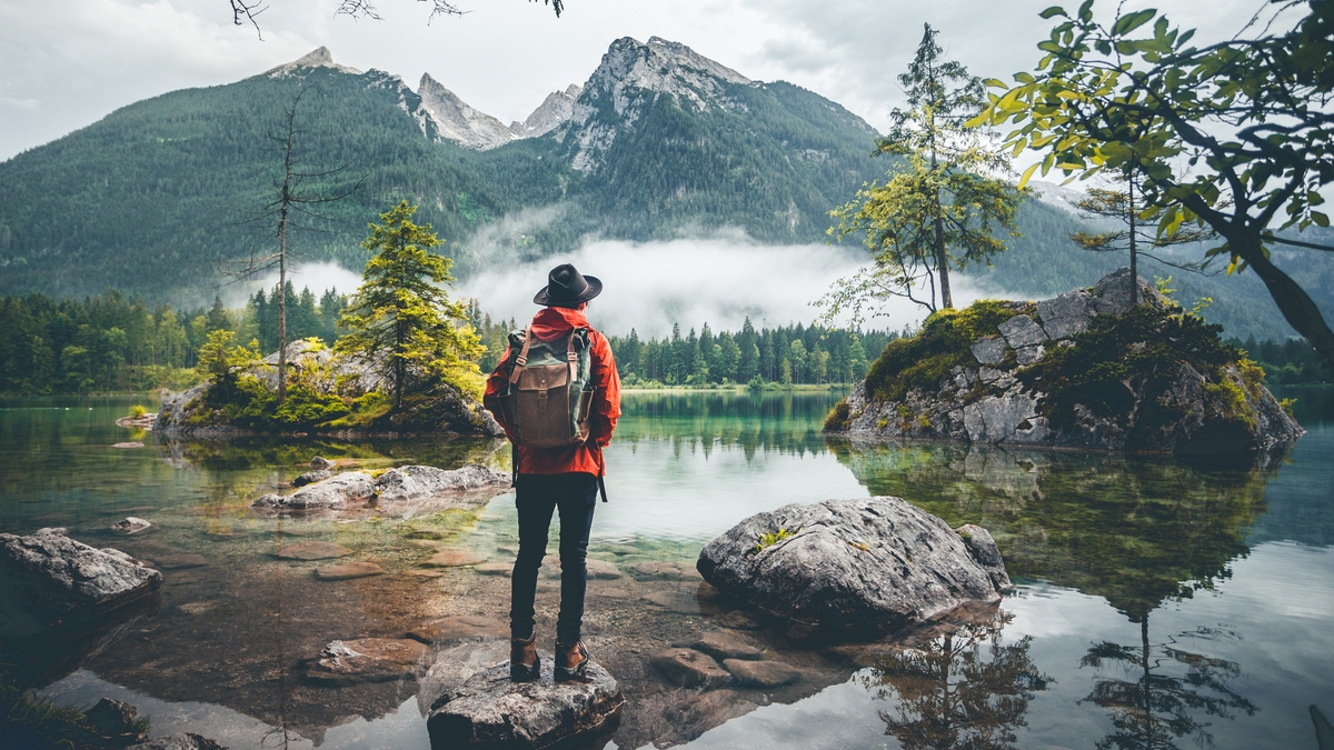 Rear View Of Woman Looking At Lake Against Mountains