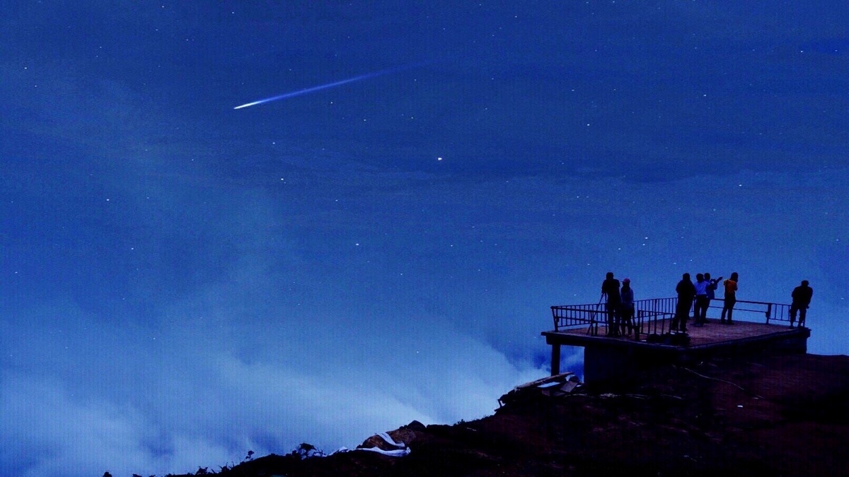 People At Observation Point On Mountain Against Blue Sky At Night