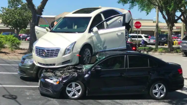This Video Of An Out-Of-Control Cadillac XTS Climbing Two Cars Is Mind-Boggling