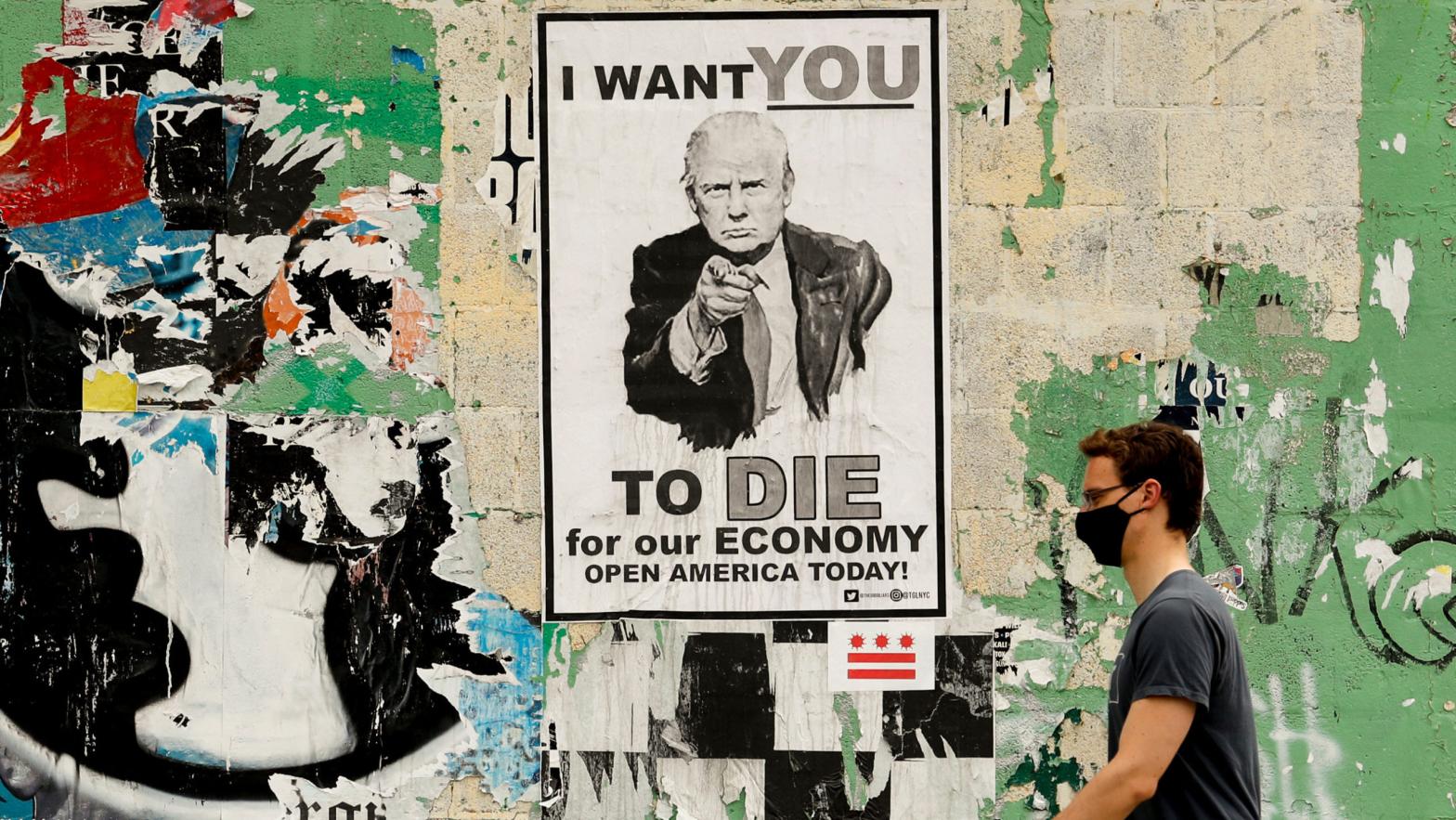 A man walks past a poster depicting President Donald Trump in the Shaw neighbourhood of Washington on May 25, 2020.  (Photo: AP)
