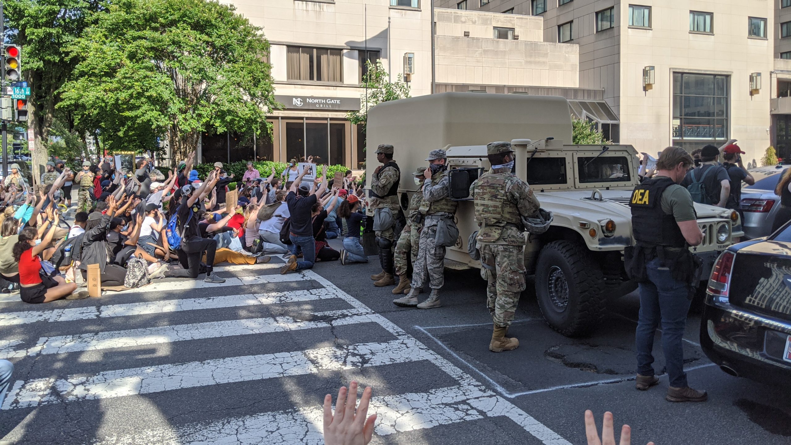 Troops on the road as protesters kneel in D.C. on June 2. (Photo: Tom McKay, Gizmodo)